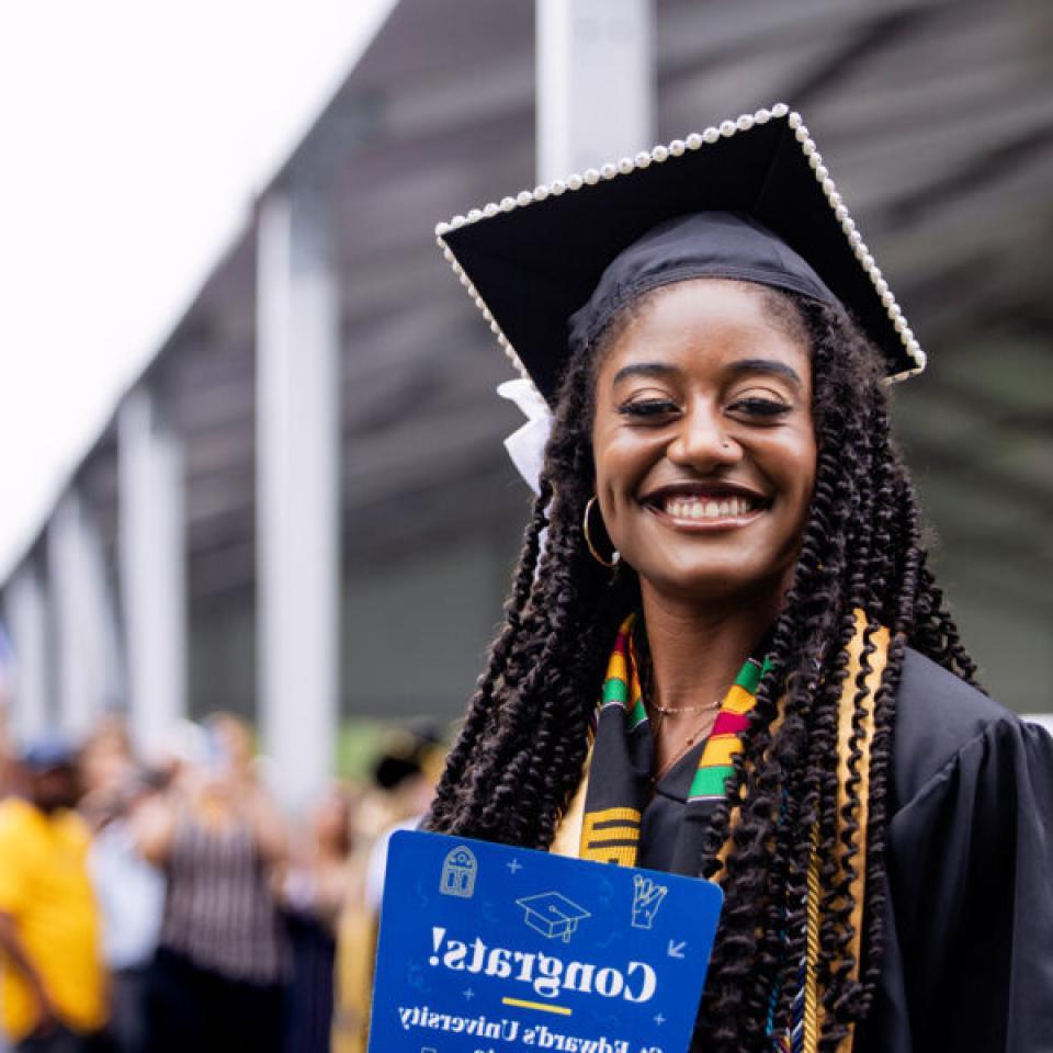 Graduating senior poses for a photo at commencement.