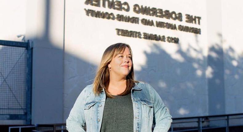 A person stands in front of a wall